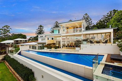 This is an example of a modern two-storey white exterior in Brisbane with a flat roof.