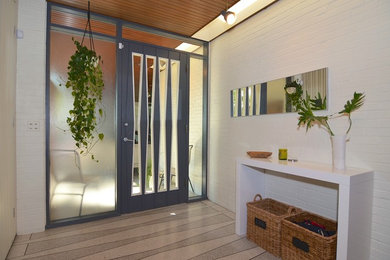 Mid-century modern entryway photo in Other