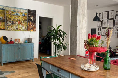 Immagine di una grande sala da pranzo industriale con pareti bianche e parquet scuro