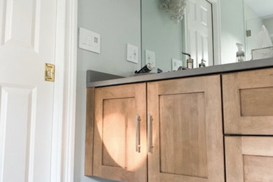 Mid-sized transitional kids' marble floor, gray floor and double-sink double shower photo in New York with furniture-like cabinets, light wood cabinets, a one-piece toilet, blue walls, an undermount sink, quartz countertops, gray countertops and a built-in vanity