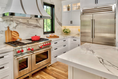 Inspiration for a mid-sized transitional u-shaped light wood floor and shiplap ceiling eat-in kitchen remodel in Other with beaded inset cabinets, white cabinets, white backsplash, an island and white countertops