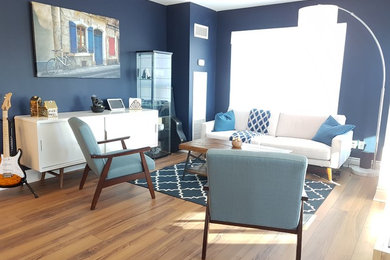 Small minimalist brown floor living room photo in Toronto with blue walls