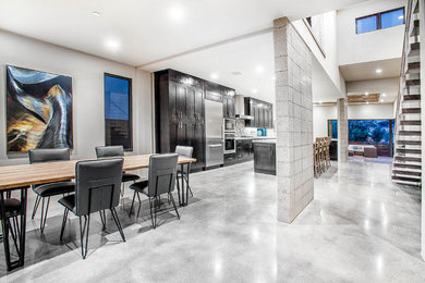 Example of a mid-sized minimalist concrete floor enclosed dining room design in San Diego with white walls