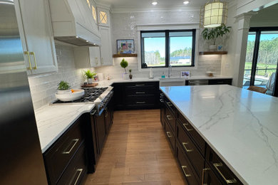 Kitchen - traditional kitchen idea in Raleigh with a farmhouse sink, white backsplash, subway tile backsplash and stainless steel appliances