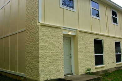 Example of a yellow two-story mixed siding exterior home design in Dallas