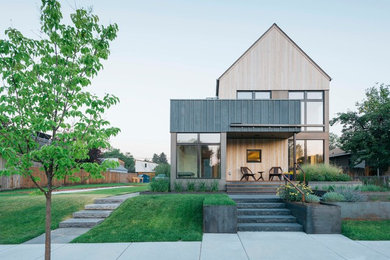 Small contemporary beige two-story wood exterior home idea in Other