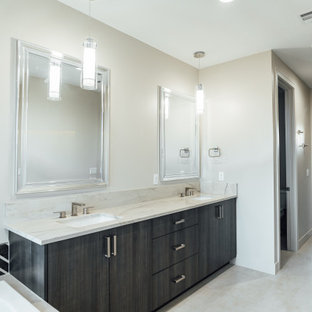 Photo of a modern master bathroom in Salt Lake City with flat-panel cabinets, brown cabinets, a corner tub, a corner shower, a two-piece toilet, beige tile, mirror tile, beige walls, ceramic floors, an undermount sink, quartzite benchtops, beige floor, an open shower, white benchtops, a shower seat, a double vanity and a built-in vanity.