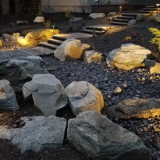 Design ideas for a mid-sized country backyard full sun formal garden for fall in Seattle with with path and natural stone pavers.