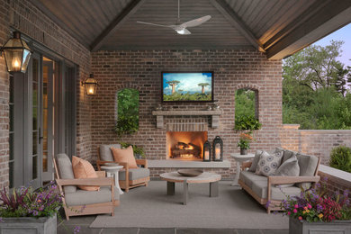Design ideas for a traditional verandah in Boston with a fire feature, tile and a roof extension.