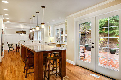 Arts and crafts galley eat-in kitchen photo in Seattle with shaker cabinets, white cabinets, marble countertops, white backsplash, ceramic backsplash and stainless steel appliances