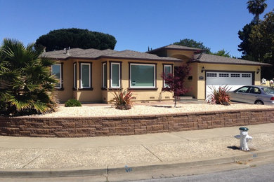 Inspiration for a mid-sized mediterranean brown one-story stucco exterior home remodel in San Francisco with a hip roof