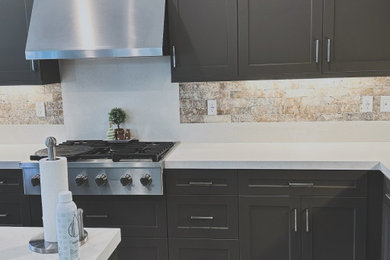 Inspiration for a rustic l-shaped porcelain tile and gray floor kitchen remodel in Orange County with a double-bowl sink, brown cabinets, quartzite countertops, beige backsplash, travertine backsplash, stainless steel appliances, an island and white countertops