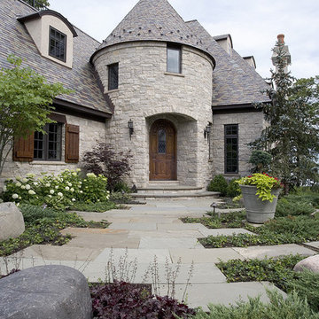 Tumbled Stone and Stucco French Provincial with Turreted Front Entry