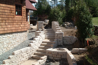 Staircase - mid-sized traditional limestone curved staircase idea in Burlington with limestone risers
