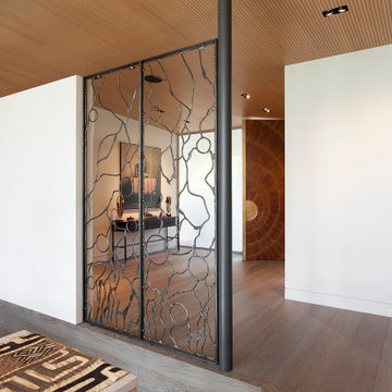 Rocky River Entry View with Bronze Screen by Christophe Côme