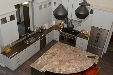 This is an example of a large transitional l-shaped kitchen pantry in Jacksonville with raised-panel cabinets, grey cabinets, panelled appliances and with island.