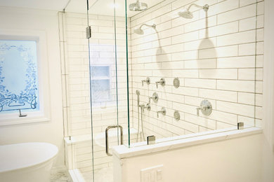 Example of a large classic master white tile and subway tile marble floor, gray floor and double-sink bathroom design in Seattle with recessed-panel cabinets, light wood cabinets, a two-piece toilet, white walls, an undermount sink, quartz countertops, a hinged shower door, white countertops and a freestanding vanity
