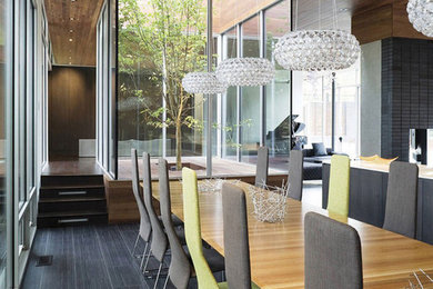 Dining room - huge modern carpeted and brown floor dining room idea in Kansas City with gray walls, a standard fireplace and a brick fireplace