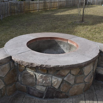 Stone walls, build in fire pit, and plank pattern stamped concrete