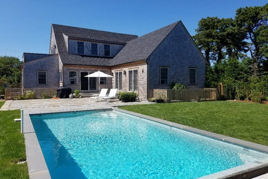 Mid-sized trendy backyard stone and rectangular lap pool photo in Boston