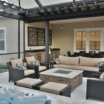 Screened area with sunken spa, fire pit and outdoor kitchen.
