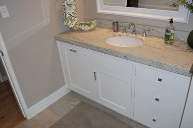 Example of a small transitional master beige tile and porcelain tile porcelain tile and beige floor bathroom design in Sacramento with recessed-panel cabinets, white cabinets, a two-piece toilet, beige walls, an undermount sink and granite countertops