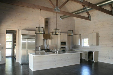 Inspiration for a mid-sized farmhouse l-shaped ceramic tile and black floor open concept kitchen remodel in Austin with a farmhouse sink, shaker cabinets, white cabinets, quartz countertops, beige backsplash, wood backsplash, stainless steel appliances and an island