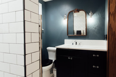 Small arts and crafts 3/4 black and white tile porcelain tile, white floor and single-sink bathroom photo in Other with shaker cabinets, black cabinets, blue walls, an undermount sink, quartz countertops, white countertops and a freestanding vanity