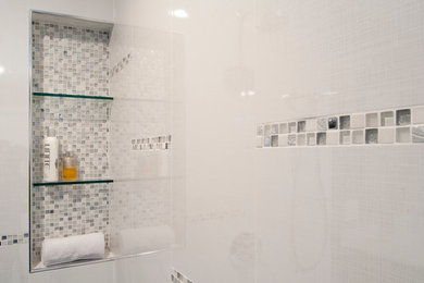 Trendy master white tile and ceramic tile porcelain tile doorless shower photo in Other with flat-panel cabinets, dark wood cabinets, a one-piece toilet and gray walls