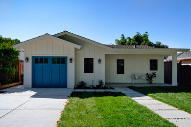 Photo of a medium sized and white beach style bungalow detached house in San Francisco with wood cladding, a pitched roof, a shingle roof, a grey roof and board and batten cladding.