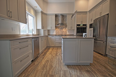Enclosed kitchen - huge contemporary u-shaped vinyl floor enclosed kitchen idea in Ottawa with an undermount sink, shaker cabinets, gray cabinets, quartz countertops, multicolored backsplash, stone tile backsplash, stainless steel appliances and an island