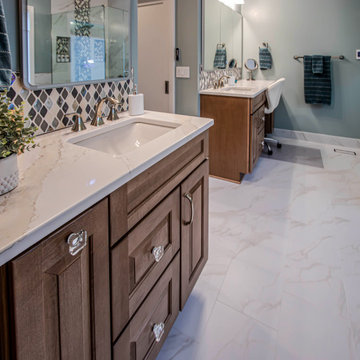 Primary Bath with Marble Look Tiled Shower and Free Standing Tub