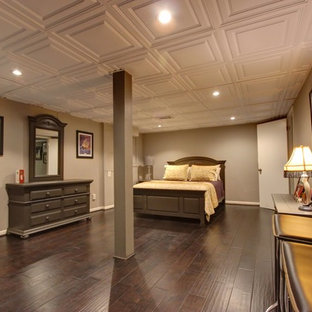 This is an example of a large contemporary walk-out basement in Atlanta with beige walls and ceramic flooring.