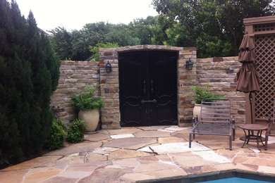 This is an example of a mid-sized backyard pool in Dallas with natural stone pavers.