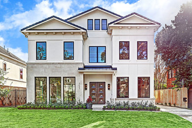 This is an example of a large transitional two-storey white house exterior in Houston with mixed siding, a gable roof and a shingle roof.