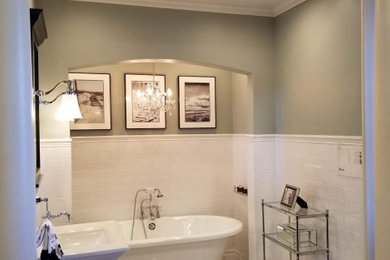 Inspiration for a mid-sized transitional white tile and subway tile freestanding bathtub remodel in Oklahoma City with green walls and a pedestal sink