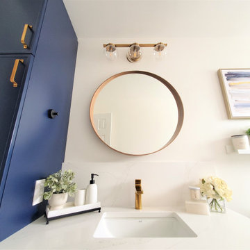 Round wood vanity mirror with brass sconce