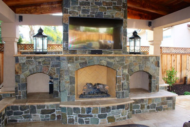 Patio - mediterranean backyard stone patio idea in San Francisco with a fire pit and a pergola