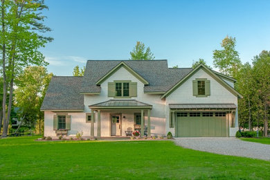 Large transitional beige two-story concrete fiberboard house exterior photo in Grand Rapids with a mixed material roof