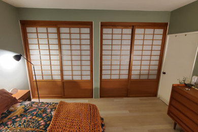 Example of a large transitional gender-neutral light wood floor and beige floor reach-in closet design in Los Angeles