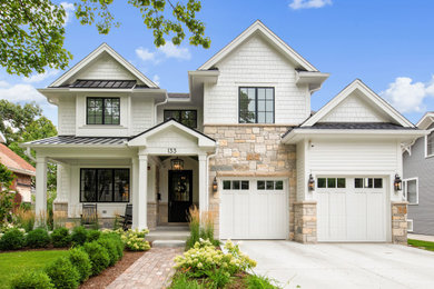 Large farmhouse white two-story mixed siding exterior home idea in Chicago with a mixed material roof