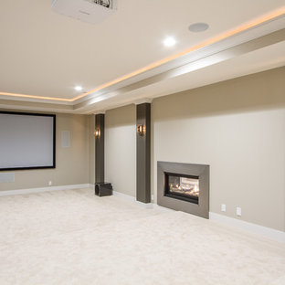 Design ideas for a large traditional enclosed home cinema in Omaha with beige walls, carpet and a projector screen.