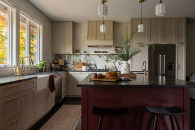 Mid-sized transitional kitchen photo in Seattle with a farmhouse sink, shaker cabinets, beige cabinets, granite countertops, an island and black countertops