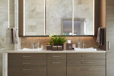 This is an example of a mid-sized contemporary master bathroom in Detroit with flat-panel cabinets, brown cabinets, beige tile, white tile, vinyl floors, a vessel sink and solid surface benchtops.