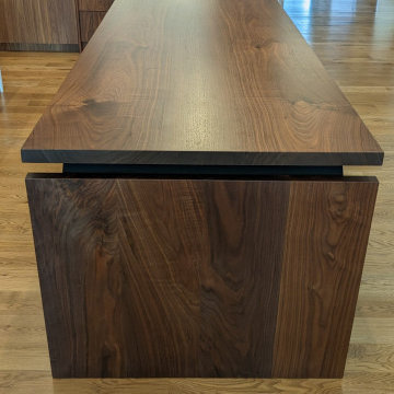 Book-matched walnut island and dining table featuring locally sourced, kiln-drie