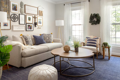 Example of a transitional medium tone wood floor and brown floor living room design in Denver with beige walls