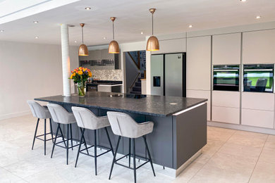 This is an example of a large modern kitchen in Berkshire with grey cabinets and an island.