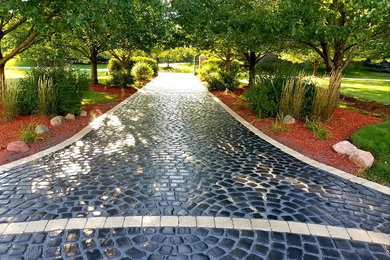 This is an example of a large traditional partial sun front yard brick landscaping in Chicago for spring.