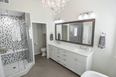 Huge minimalist master porcelain tile, beige floor and double-sink bathroom photo in Los Angeles with shaker cabinets, white cabinets, a two-piece toilet, an undermount sink, quartz countertops, a hinged shower door, white countertops and a built-in vanity