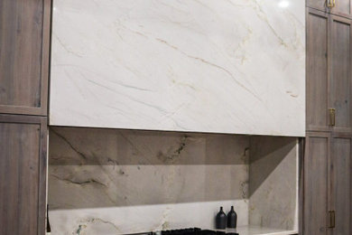 Inspiration for a huge contemporary eat-in kitchen remodel in Salt Lake City with a farmhouse sink, quartzite countertops, white backsplash, stainless steel appliances and white countertops